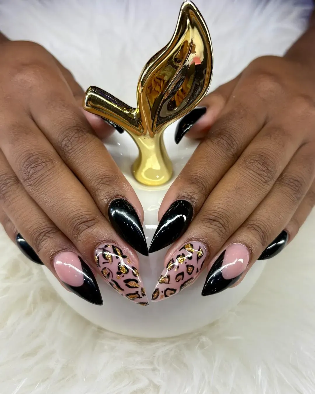 Black and pink pointed nails with gold leopard-print accent designs