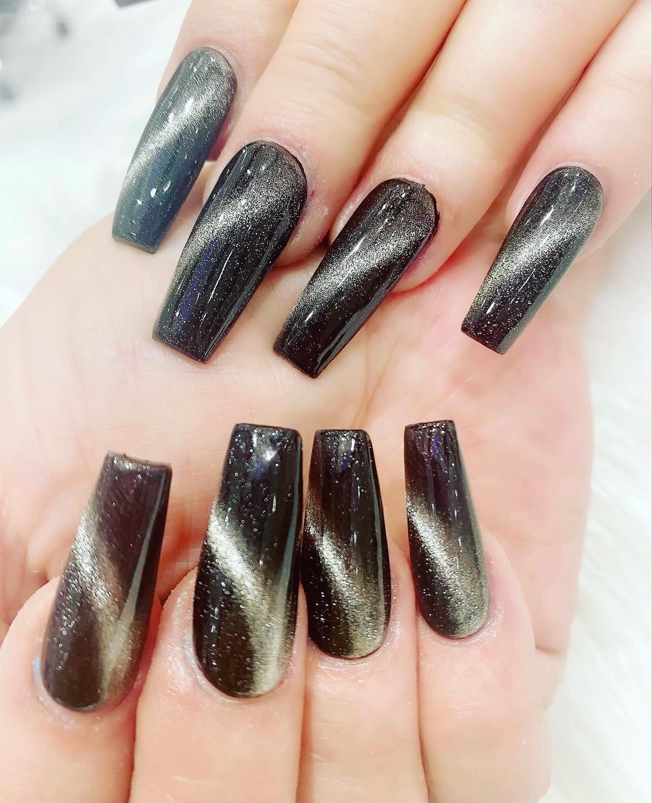 Silver cat eye shimmer on dark coffin-shaped nails