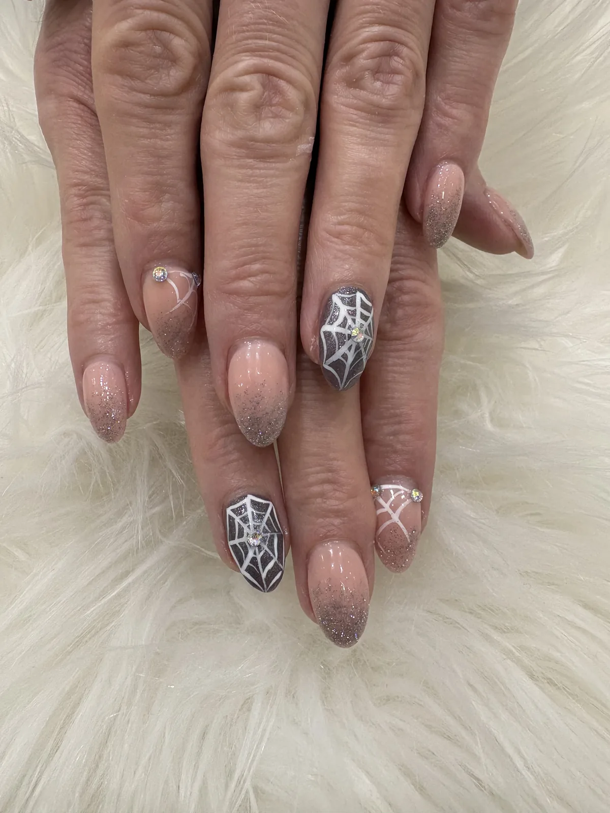 Almond nails with silver glitter, white spiderwebs and gems at Apple Nailed It Spa in Gilbert