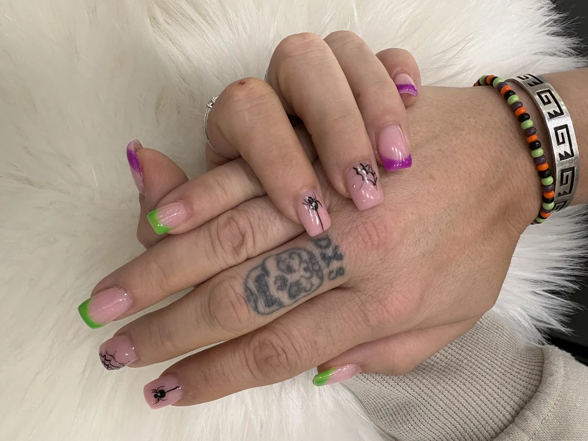Green and purple French tips with black spiders and webs at Apple Nailed It Spa in Gilbert, AZ