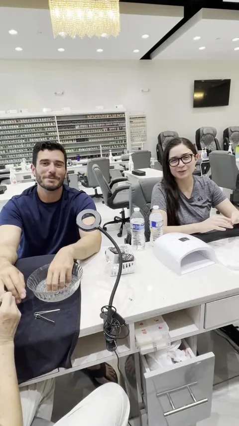 Two guests sharing their review inside Apple Nailed It Spa