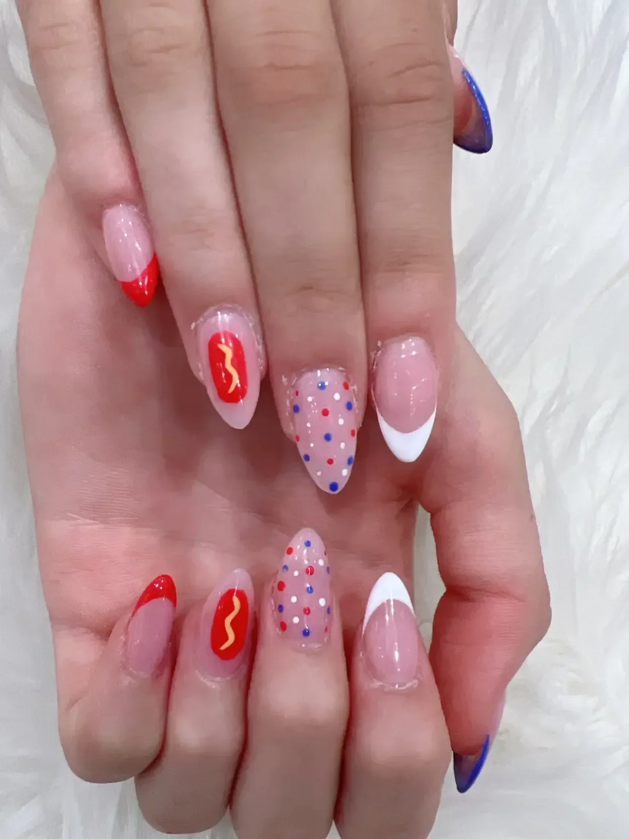 Red and white French tips with dotted accent nails